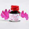 Close-up of Papier Plume New Orleans Collection fountain pen ink bottle with vibrant ink inside.