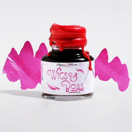 Close-up of Papier Plume New Orleans Collection fountain pen ink bottle with vibrant ink inside.