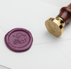 Papier Plume wax seal with X-script monogram design on white background, featuring elegant script initials and decorative details.