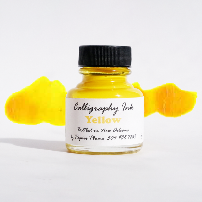 Yellow bottled calligraphy ink from Papier Plume, featuring smooth, vibrant ink for artistic lettering and calligraphy projects.