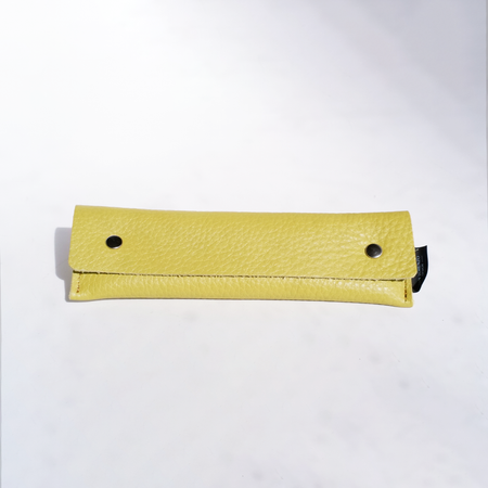 Yellow San Lorenzo long pen case with a smooth cylindrical design and zip closure, ideal for storing and organizing pens.