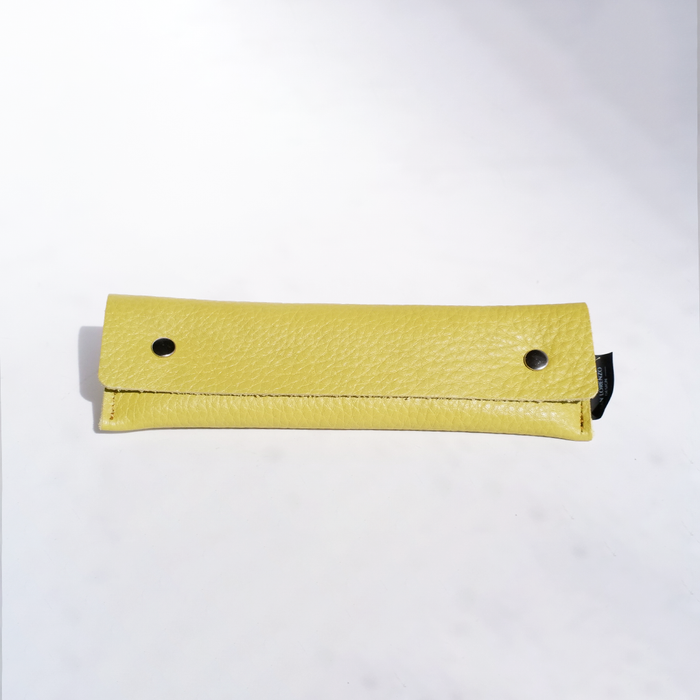 Yellow San Lorenzo long pen case with a smooth cylindrical design and zip closure, ideal for storing and organizing pens.