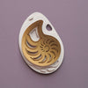 Gold paper fossil art of an ammonite shell by Assembli, showcasing intricate fossil details and artistic design.