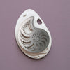 Silver paper fossil art depicting a detailed ammonite fossil, created by Assembli.