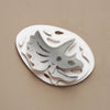 Silver paper fossil art of a Triceratops by Assembli, showcasing detailed prehistoric dinosaur design on textured paper.