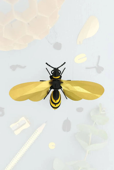 Gold paper wasp craft made by Assembli featuring detailed wings and body for creative DIY projects.