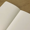 Medium Schemes Journal by The Mincing Mockingbird featuring a textured cover with intricate patterns and a sturdy binding.