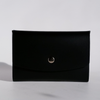 Black Papier Plume Swatch Book Card Holder made of regenerated leather, open to show multiple card slots.