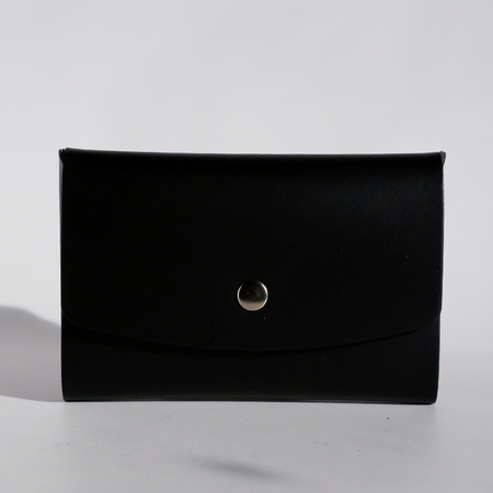 Black Papier Plume Swatch Book Card Holder made of regenerated leather, open to show multiple card slots.