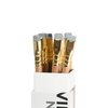 Blackwing Natural pencils with black and white striped barrels and erasers, arranged in a row on a white background.