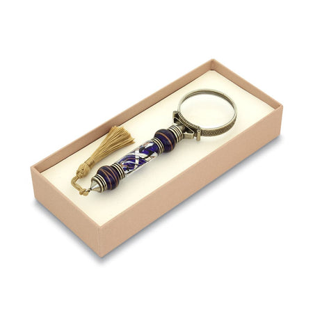 Bortoletti Murano glass magnifying glass with amber handle, silver leaf accents, and tassel, showcasing intricate craftsmanship.