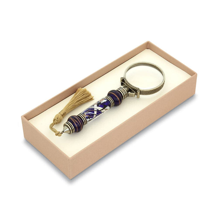 Bortoletti Murano glass magnifying glass with amber handle, silver leaf accents, and tassel, showcasing intricate craftsmanship.