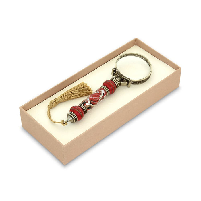 Bortoletti Murano glass magnifying glass with amber handle, silver leaf accents, and tassel for elegant viewing.