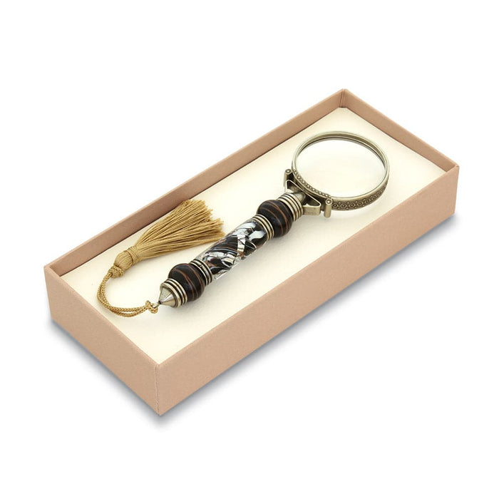 Bortoletti Murano glass magnifying glass with amber handle, silver leaf detailing, and decorative tassel.
