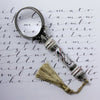 Bortoletti Murano glass magnifying glass with amber handle, silver leaf accents, and decorative tassel.