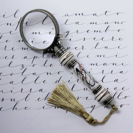 Bortoletti Murano glass magnifying glass with amber handle, silver leaf accents, and decorative tassel.