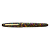 Esterbrook Estie fountain pen with gold fittings, showcasing a botanical garden background. Elegant writing instrument.