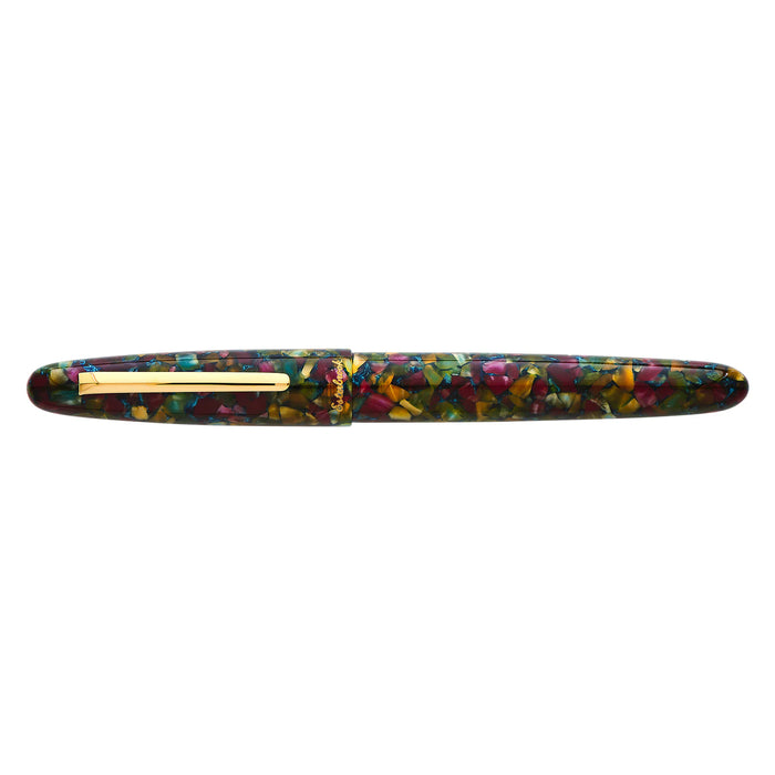 Esterbrook Estie fountain pen with gold fittings, showcasing a botanical garden background. Elegant writing instrument.