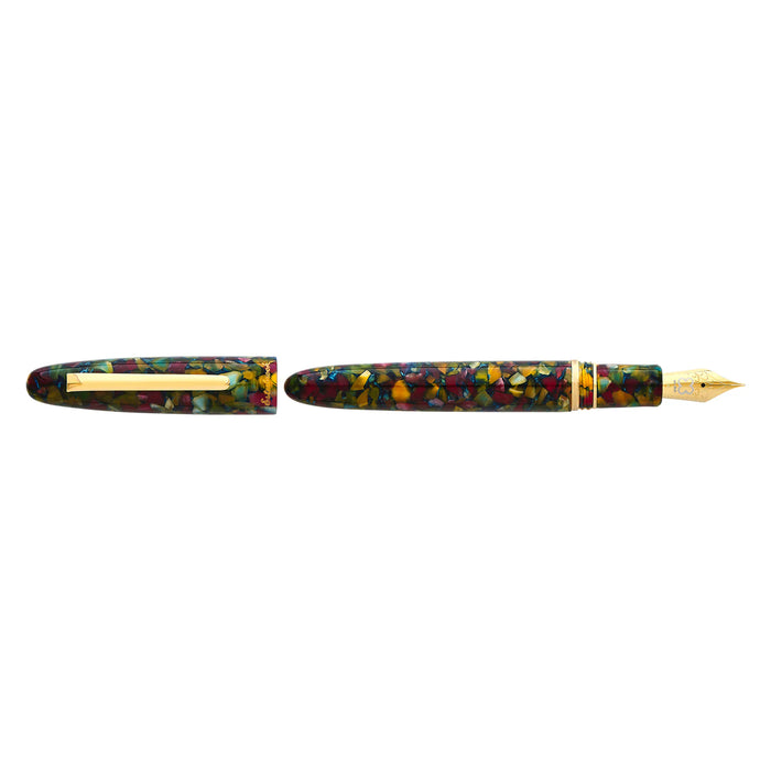 Esterbrook Estie fountain pen with gold fittings, displayed on a botanical gardens background, showcasing the elegant writing instrument.
