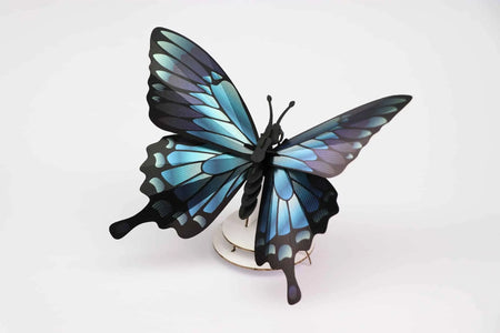 Blue mountain butterfly craft made from paper, featuring vibrant blue wings and detailed design by Assembli.