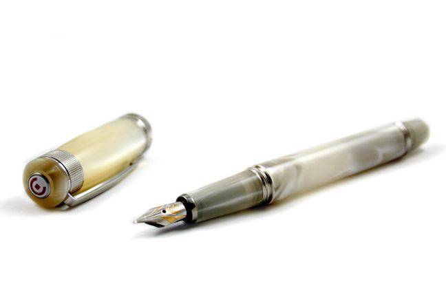 Cleo Skribent Aura fountain pen with mother of pearl finish and extra-fine nib, showcasing elegant design and luxurious detailing.
