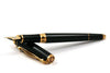 Cleo Skribent Skribent Gold fountain pen with gold accents and smooth ink nib, designed for elegant writing.