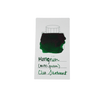 Cleo Skribent bottled fountain pen ink in Moosgrun moss green, shown in a glass ink bottle with green ink visible inside.