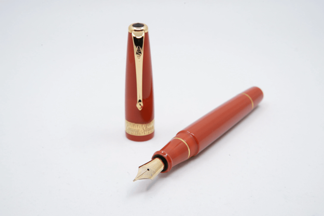 Conway Stewart Orange Duofold fountain pen with fine nib, featuring a sleek orange barrel and elegant design.