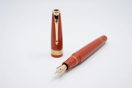 Conway Stewart Orange Duofold fountain pen with fine nib, featuring a sleek orange barrel and elegant design.