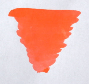 Bottle of Diamine Coral fountain pen ink showing vibrant coral-colored ink in a clear glass bottle.