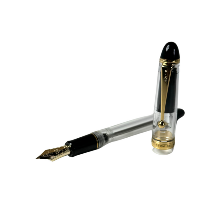 Pilot Custom 823 fountain pen with clear resin barrel and gold accents, showcasing its elegant design and craftsmanship.