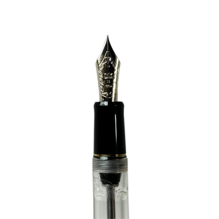 Pilot Custom 823 fountain pen with clear resin barrel and gold accents, showcasing a sleek, elegant writing instrument.