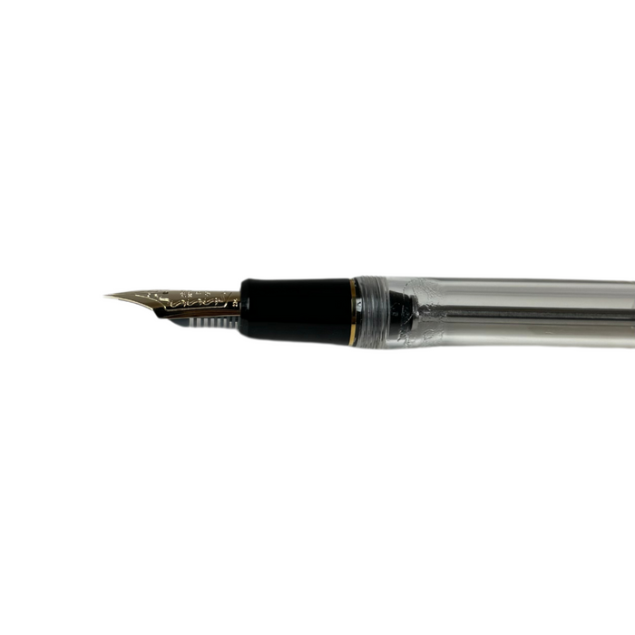 Pilot Custom 823 fountain pen with clear resin body and gold accents, showcasing its elegant design and craftsmanship.