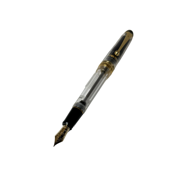 Pilot Custom 823 fountain pen with transparent clear barrel and gold accents, showcasing a luxurious writing instrument.