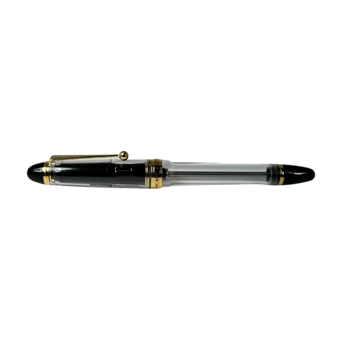 Pilot Custom 823 fountain pen with clear barrel and gold accents, showcasing its elegant design and fine nib.