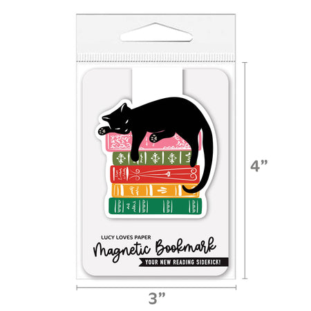 Magnetic cat bookmark attached to a book page, featuring a cute cat design by Lucy Loves Paper for book lovers.
