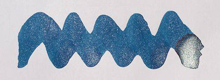 Diamine Shimmertastic Starlit Sea shimmering fountain pen ink in a glass bottle showing vibrant blue ink with shimmer particles.