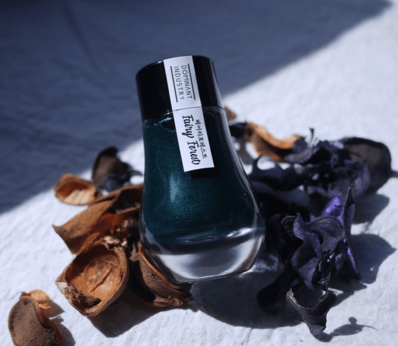 Bottle of Dominant Industry Pearl Inks fountain pen ink in Apple Blossom color, with a clear label and vibrant pink hue.