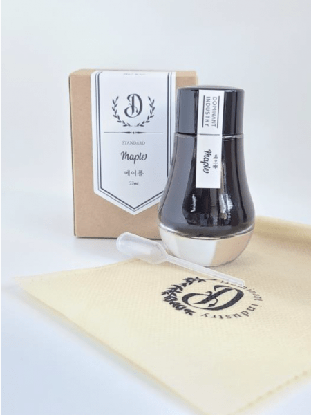 Black fountain pen ink in a bottle from Dominant Industry's Standard Inks collection, suitable for elegant writing and art projects.