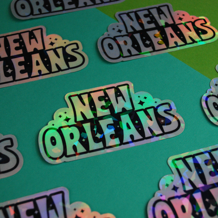 Holographic New Orleans sticker by BBall Y'all featuring vibrant, reflective city-themed design on a clear background.