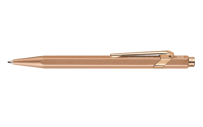 Caran D'Ache Ballpoint Pen 849 in brushed rose finish with sleek metal clip and matching protective case.