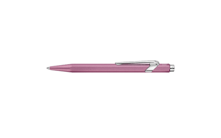 Caran D'Ache Ballpoint Pen 849 with a vibrant rose-colored barrel and sleek metal clip, showcasing its stylish design.