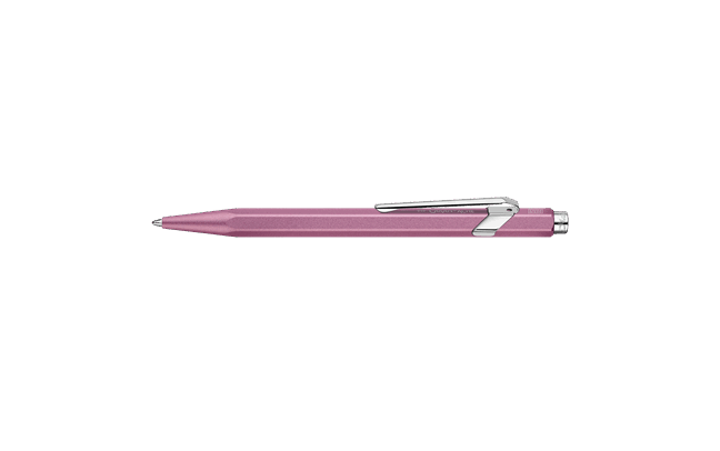 Caran D'Ache Ballpoint Pen 849 with a vibrant rose-colored barrel and sleek metal clip, showcasing its stylish design.