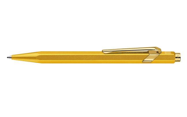 Gold Caran D'Ache Ballpoint Pen 849 with sleek design, displayed with its elegant carrying case.