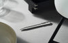 Caran D'Ache Platinum-Coated ECRIDOR AVENUE rollerball pen with detailed close-up of the gold finish and elegant design.