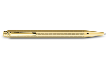 Caran D'Ache Gilded Ecridor Chevron ballpoint pen with gold accents, featuring a sleek chevron design and polished metal finish.