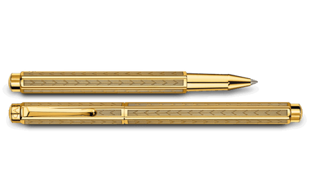 Caran D'Ache Gilded Ecridor Chevron rollerball pen with gold accents and intricate chevron pattern on the barrel.