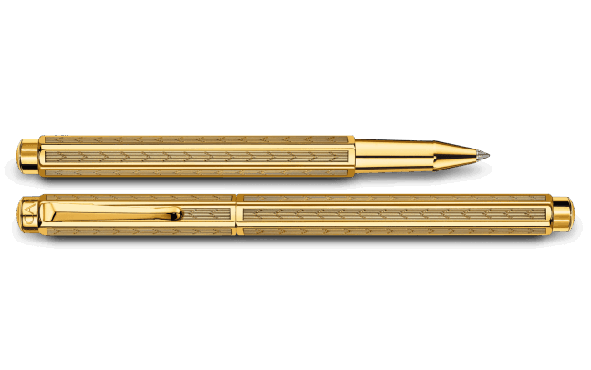Caran D'Ache Gilded Ecridor Chevron rollerball pen with gold accents and intricate chevron pattern on the barrel.