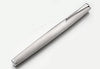 Lamy Studio fountain pen with brushed steel finish, sleek design, and metal clip, showcasing its elegant craftsmanship.