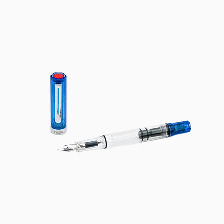 Twsbi Eco transparent blue fountain pen with clear body and silver accents, showcasing its nib and ink reservoir.